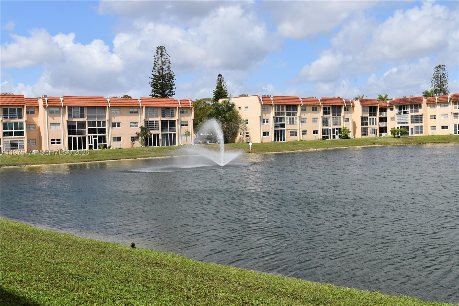 2801 North Pine Island Road, Unit 112 Sunrise, FL 33322 - Photo 42 of 49 a front view of a house with a yard