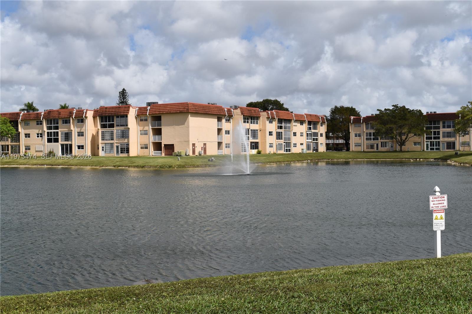 2801 North Pine Island Road, Unit 112 Sunrise, FL 33322 - Photo 43 of 49 a front view of a house with a lake view