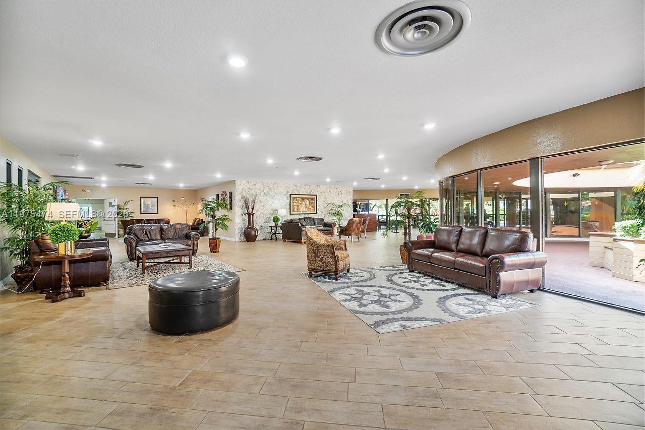 2801 North Pine Island Road, Unit 112 Sunrise, FL 33322 - Photo 45 of 49 a living room with furniture and a table