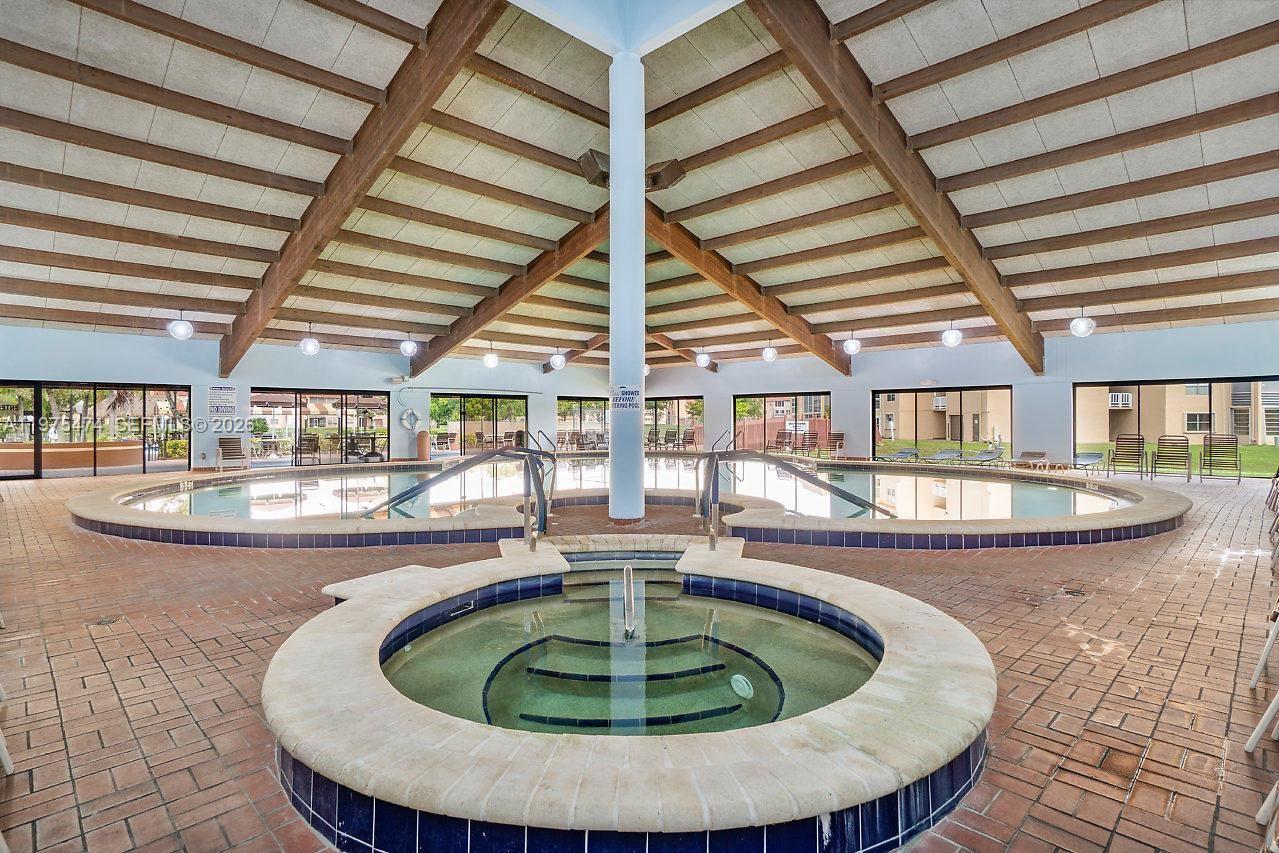 2801 North Pine Island Road, Unit 112 Sunrise, FL 33322 - Photo 48 of 49 a view of a swimming pool with seating space