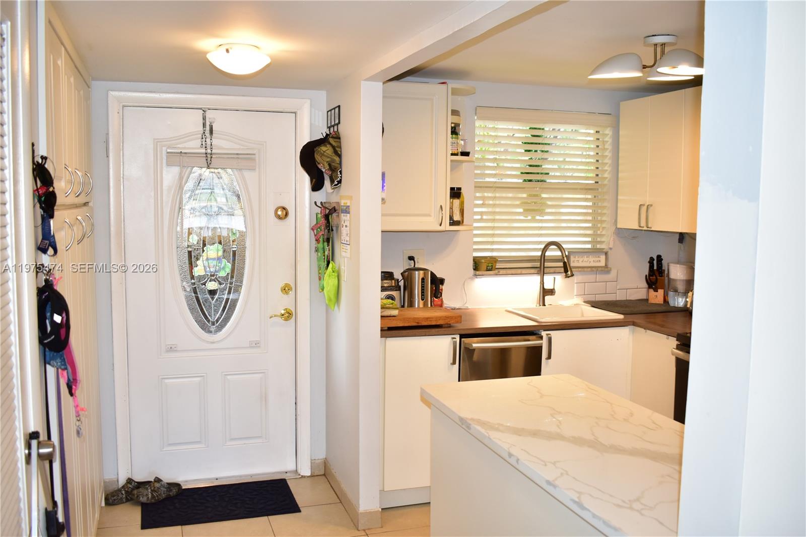 2801 North Pine Island Road, Unit 112 Sunrise, FL 33322 - Photo 7 of 49 a kitchen with a refrigerator a sink and a window