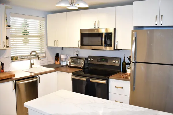 a kitchen with a sink stove and refrigerator