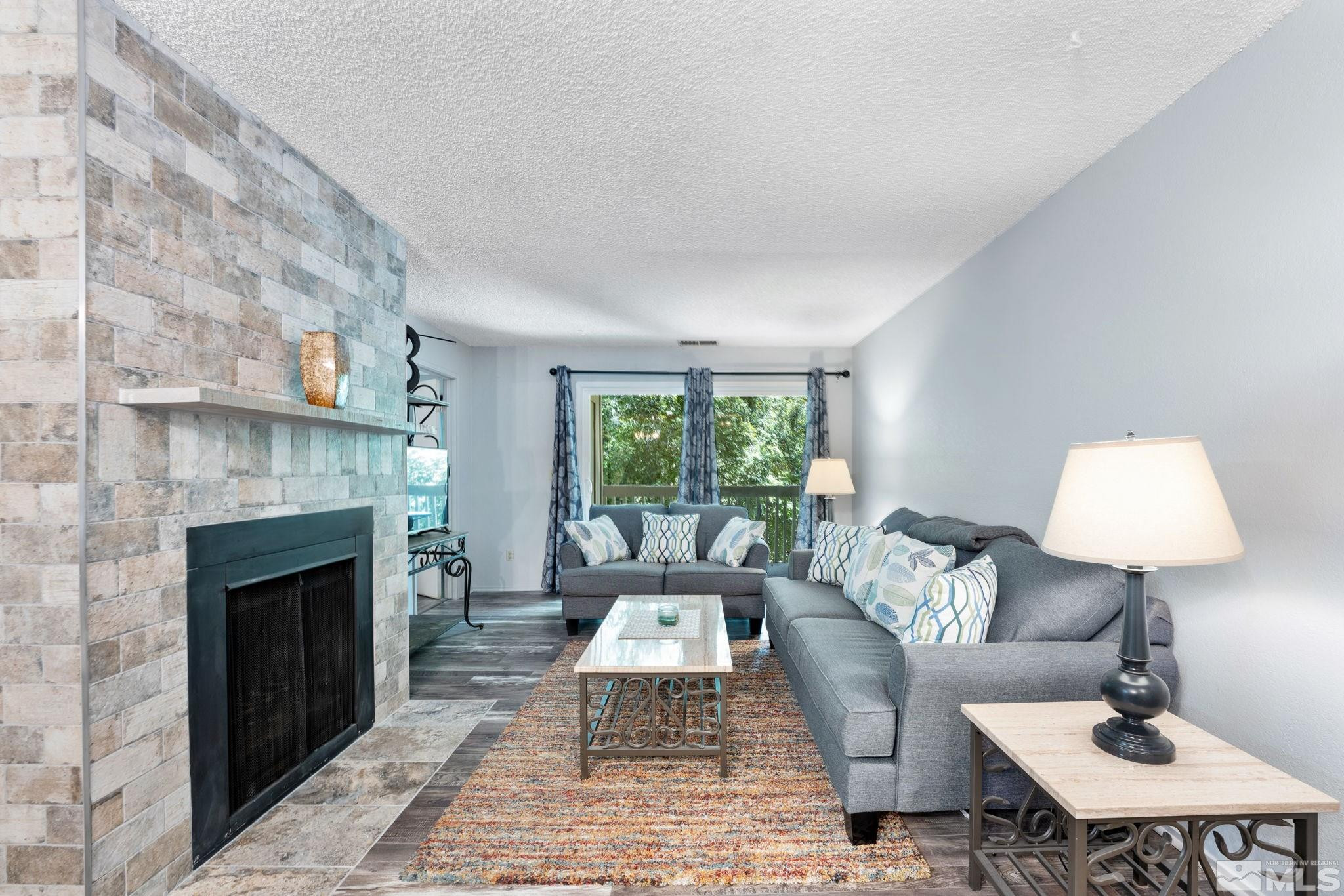 2300 Dickerson Road, Unit 64 Reno, NV 89503 - Photo 1 of 29 a living room with furniture and a fireplace