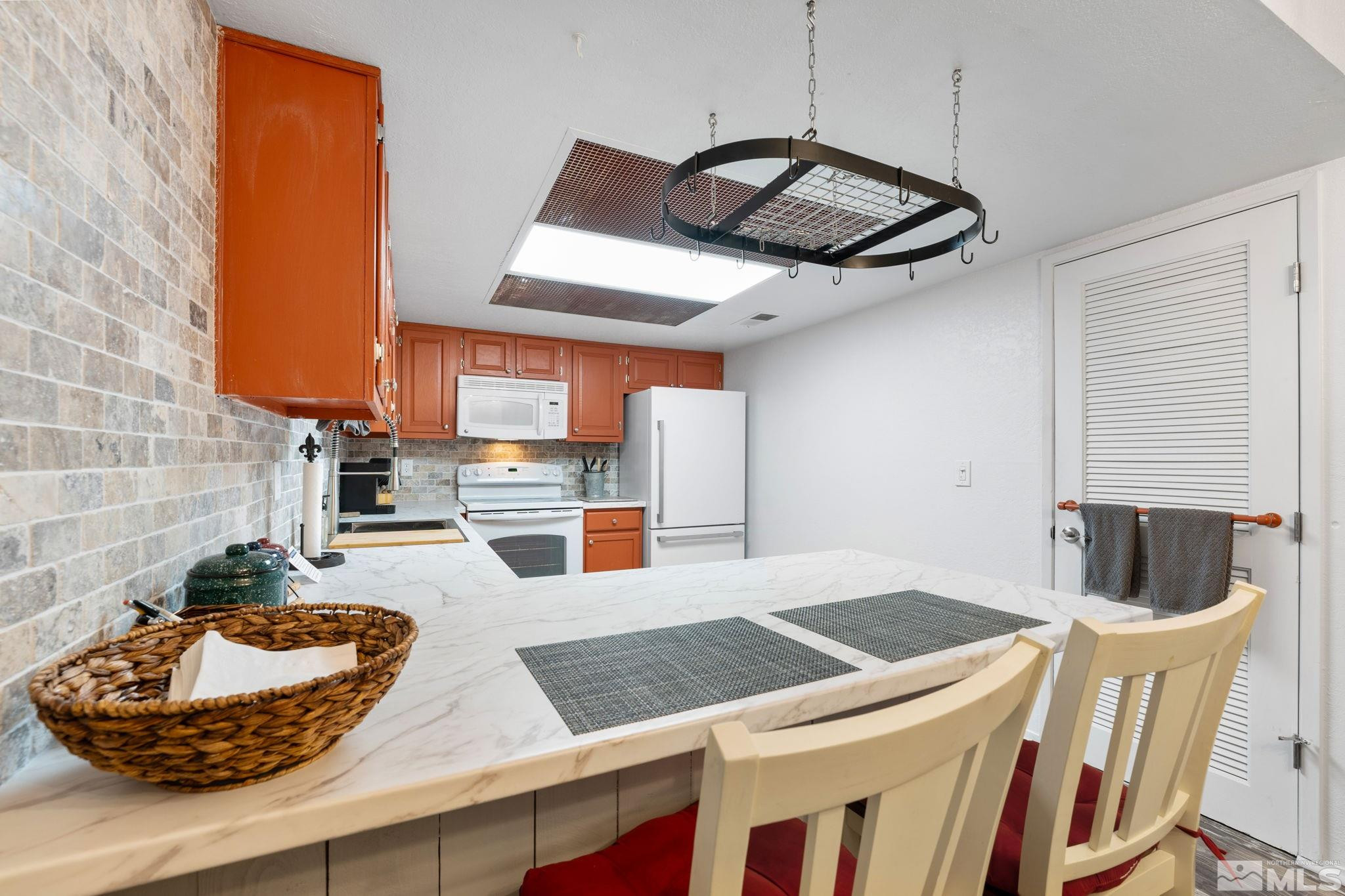 2300 Dickerson Road, Unit 64 Reno, NV 89503 - Photo 8 of 29 a kitchen with stainless steel appliances granite countertop a sink dishwasher and a stove with wooden floor