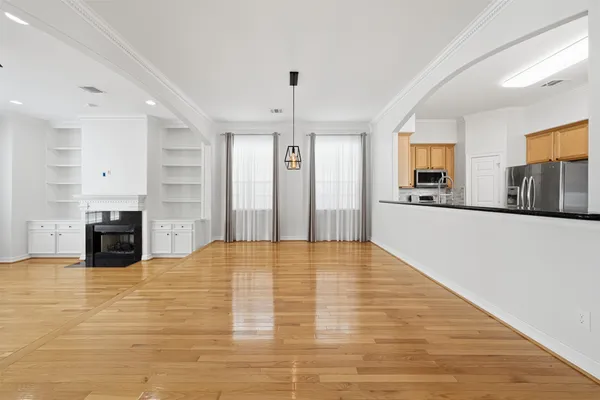 a view of a kitchen with furniture and wooden floor