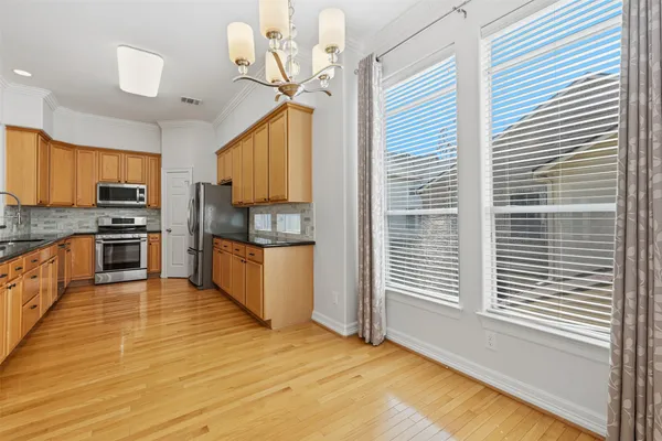 a kitchen with stainless steel appliances a refrigerator and a stove top oven
