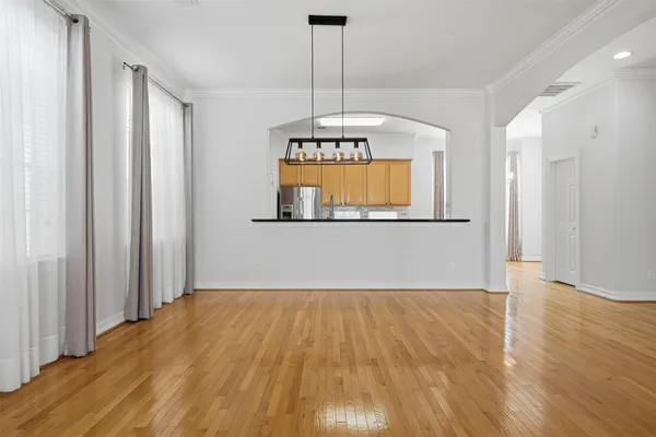 a view of a room with wooden floor and a window