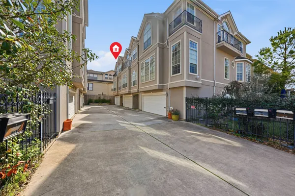 a front view of multi story residential apartment building with yard