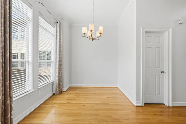 a view of a room with wooden floor and white walls