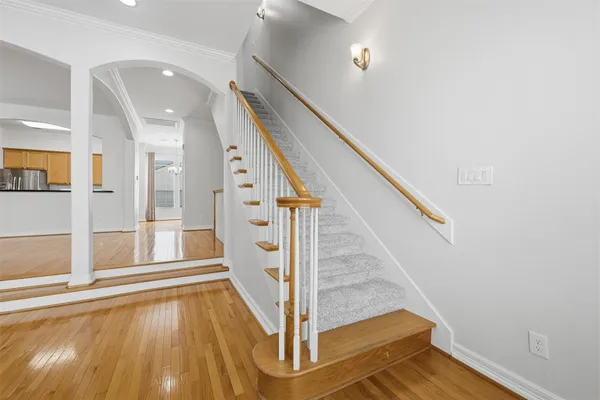 a view of entryway with wooden floor and stairs
