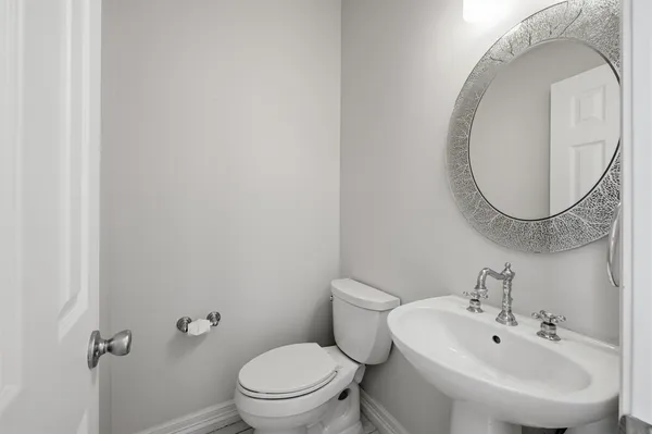 a white toilet sitting next to a bathroom sink