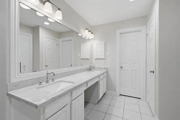 a bathroom with a sink a vanity and a mirror