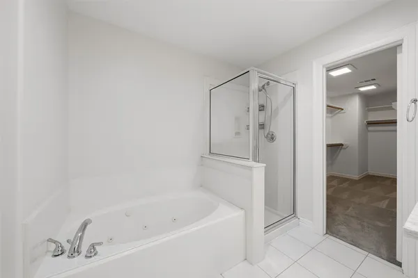 a bathroom with a bathtub and a shower