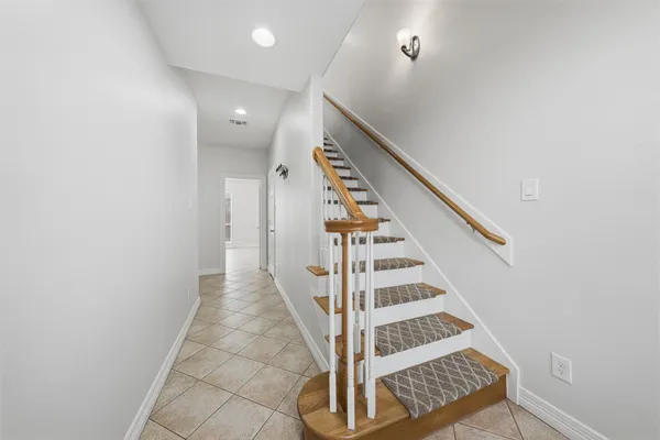 a view of entryway with wooden floor and stairs