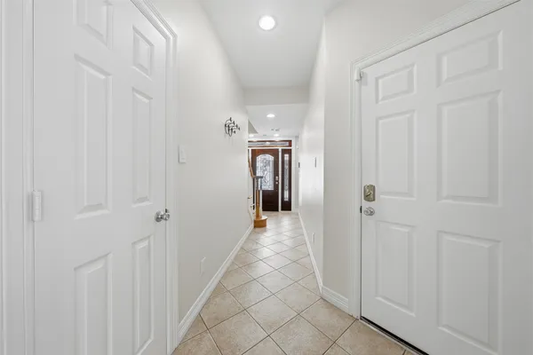 a view of a hallway with wooden shelves
