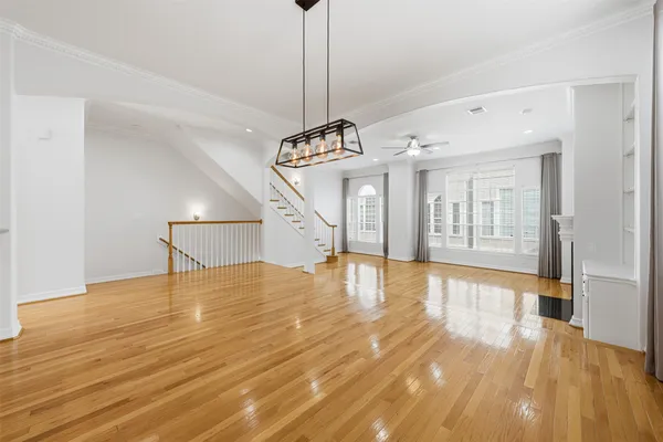 a view of a room with wooden floor and flat screen tv