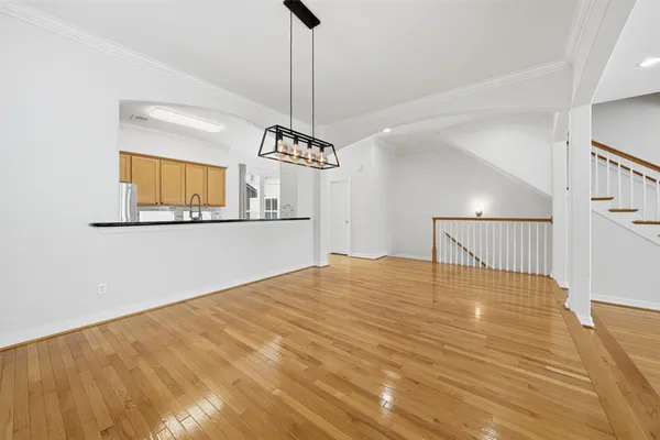 a view of a room with wooden floor and staircase