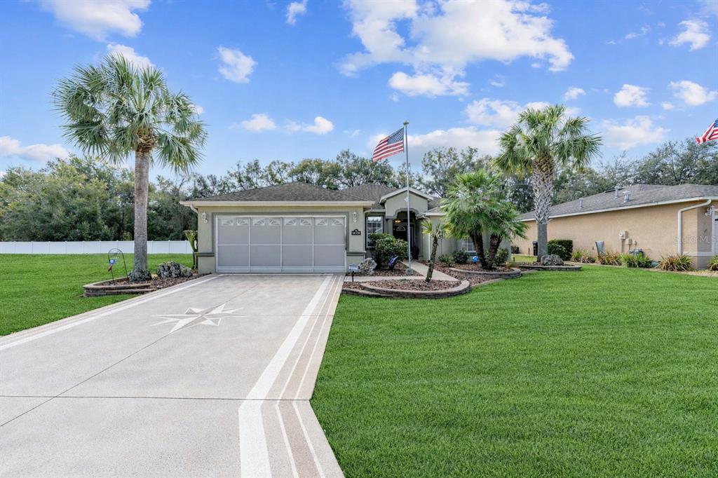 16339 Southwest 14th Avenue Road Ocala, FL 34473 - Photo 1 of 22 a front view of a house with garden and a tree
