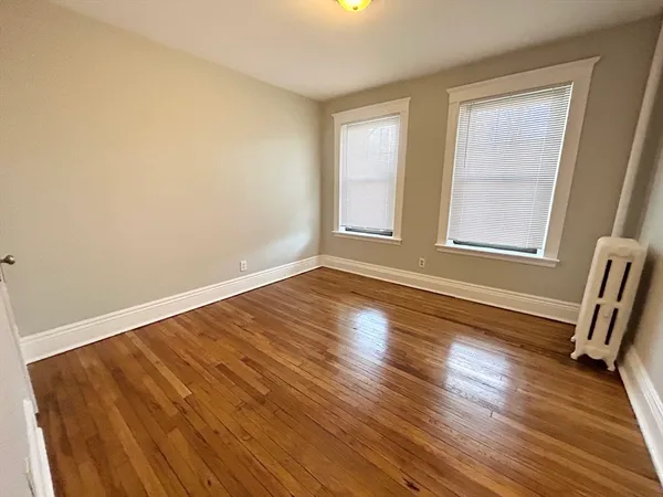 a view of wooden floor and windows in a room