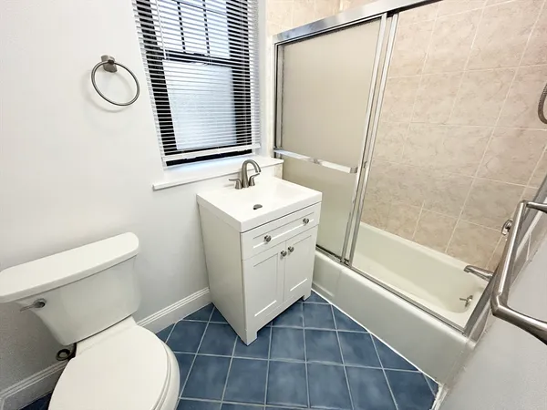 a bathroom with a toilet sink and a mirror