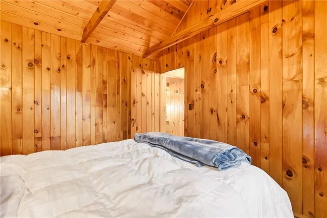 a view of empty room with wooden floor and windows