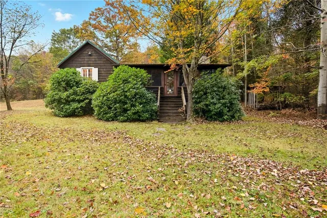 a backyard of a house with large trees