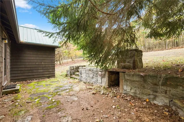 a view of house with backyard