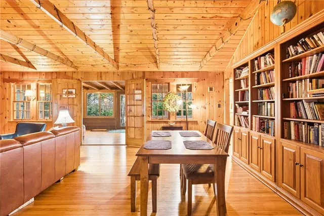 a dining room with furniture and wooden floor