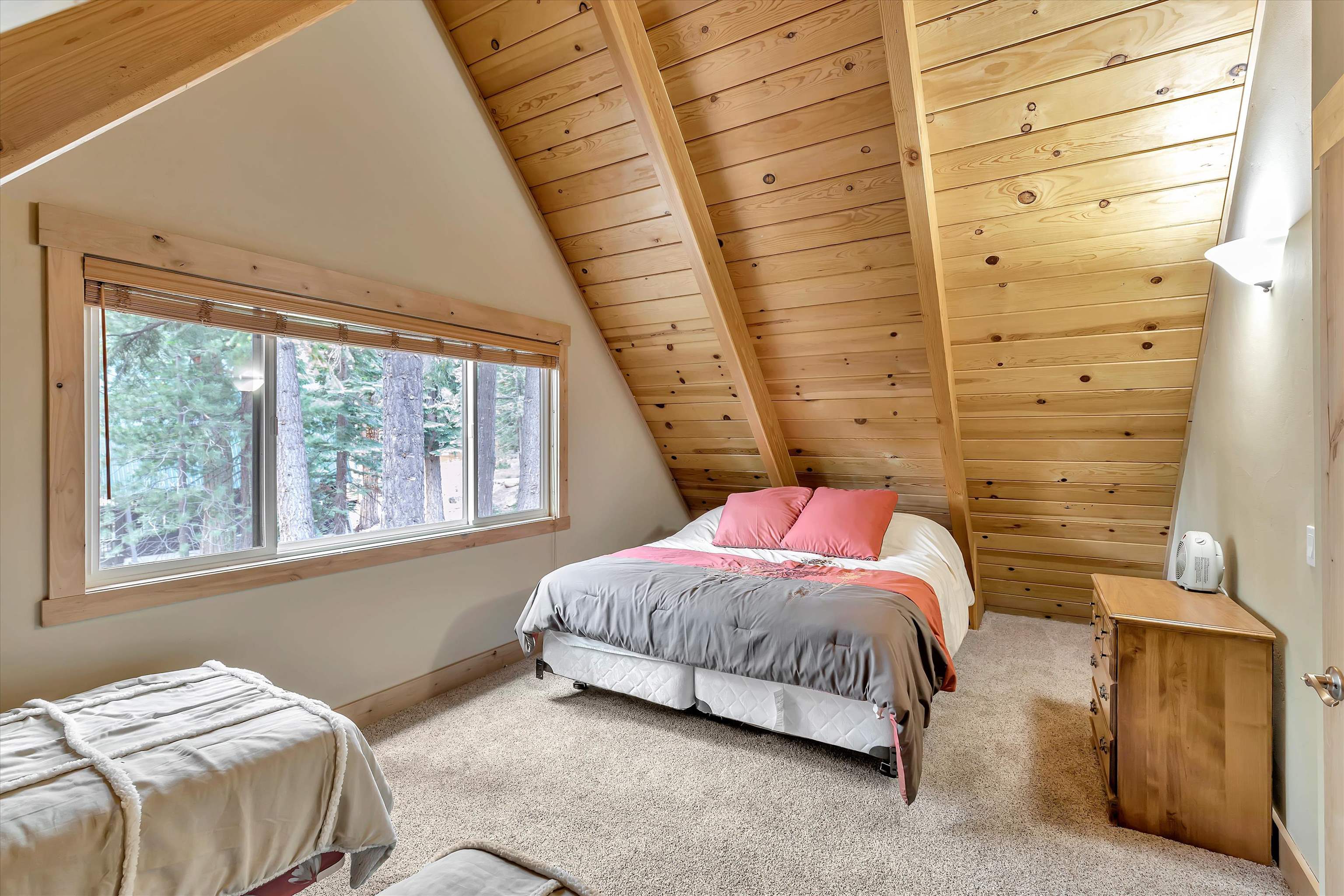 505 Granite Road Carnelian Bay, CA 96140 - Photo 11 of 20 a bedroom with a bed and a window
