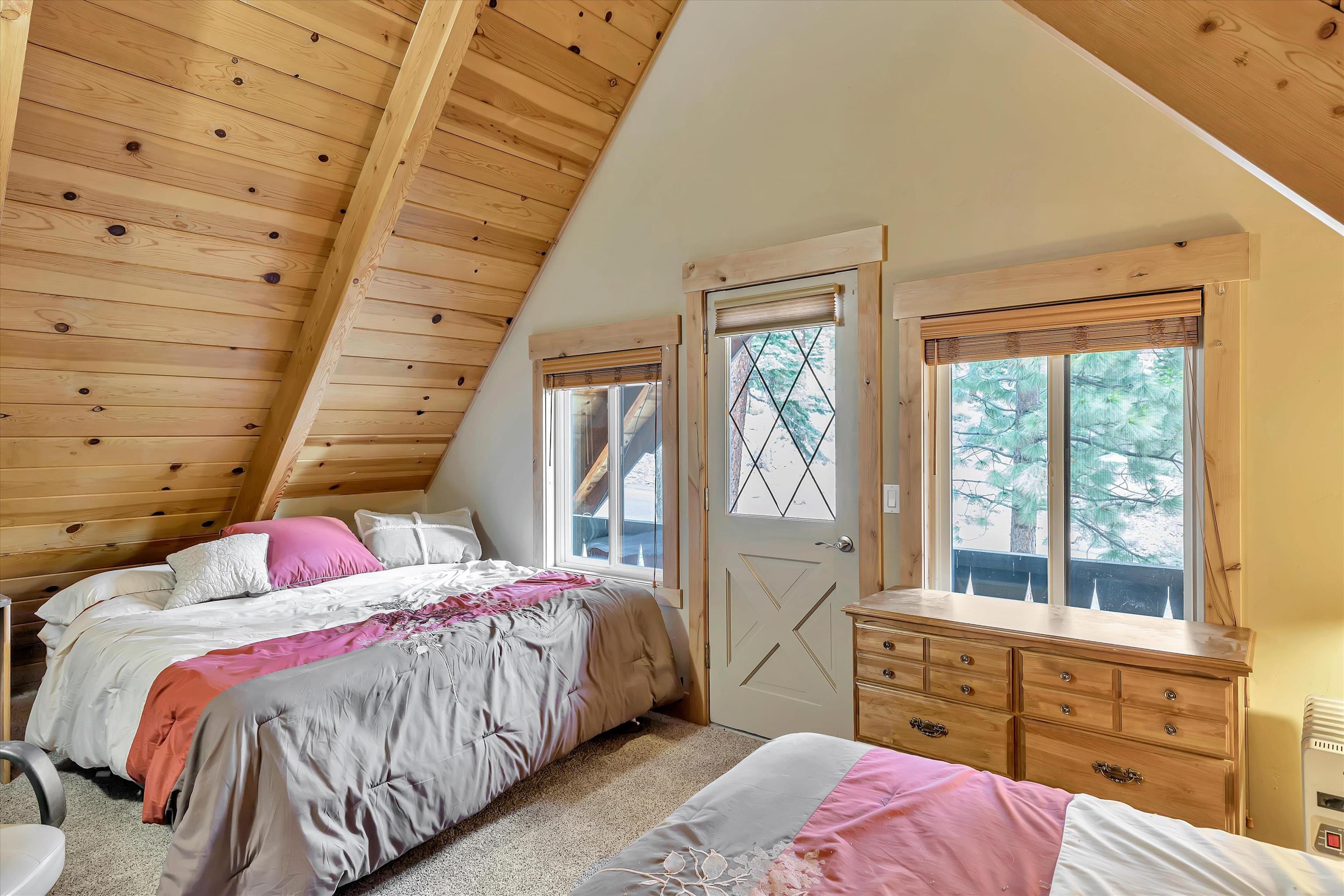 505 Granite Road Carnelian Bay, CA 96140 - Photo 12 of 20 a bedroom with a bed and a window