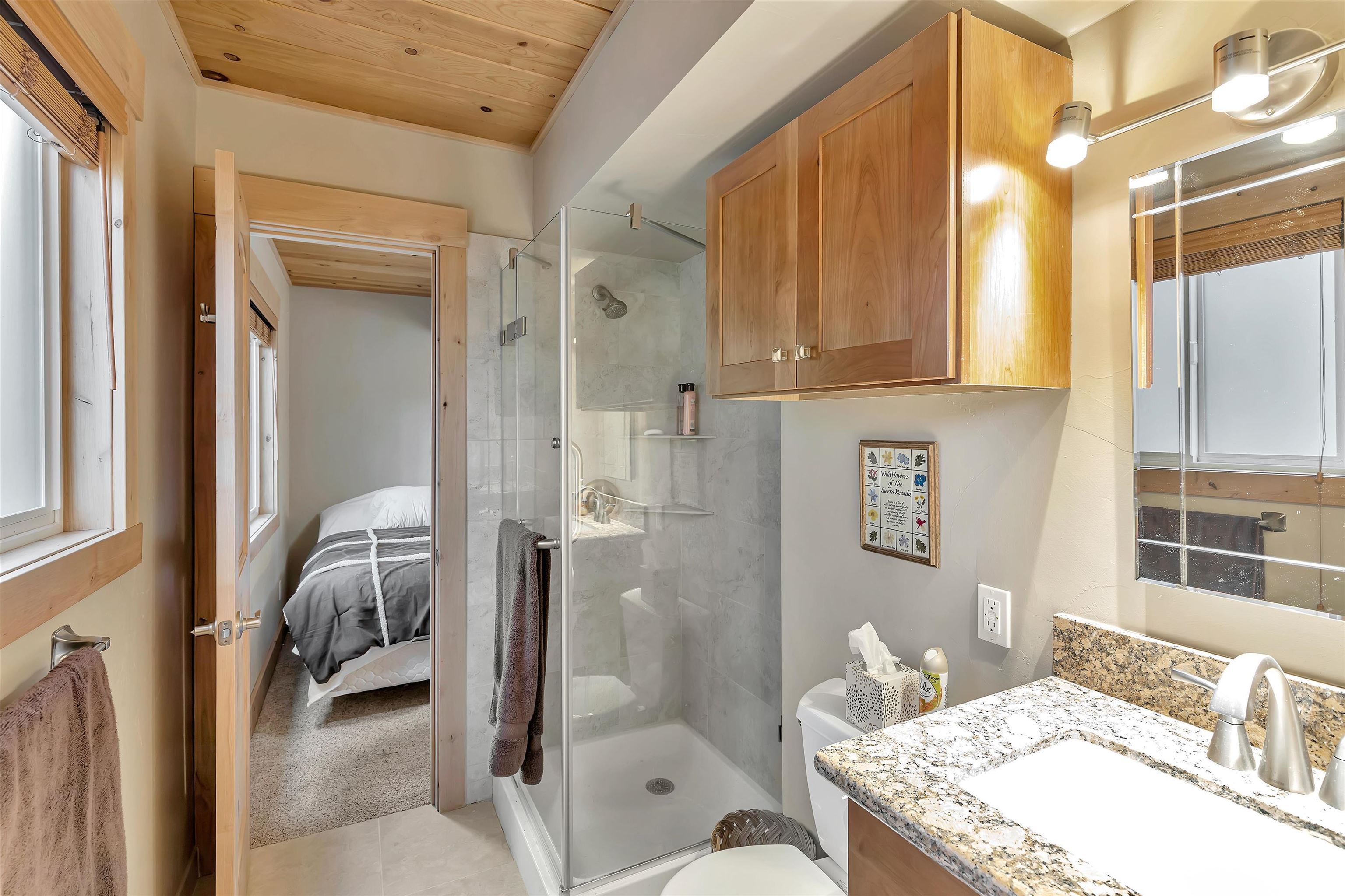 505 Granite Road Carnelian Bay, CA 96140 - Photo 15 of 20 a en suite bathroom with a granite countertop sink and a mirror