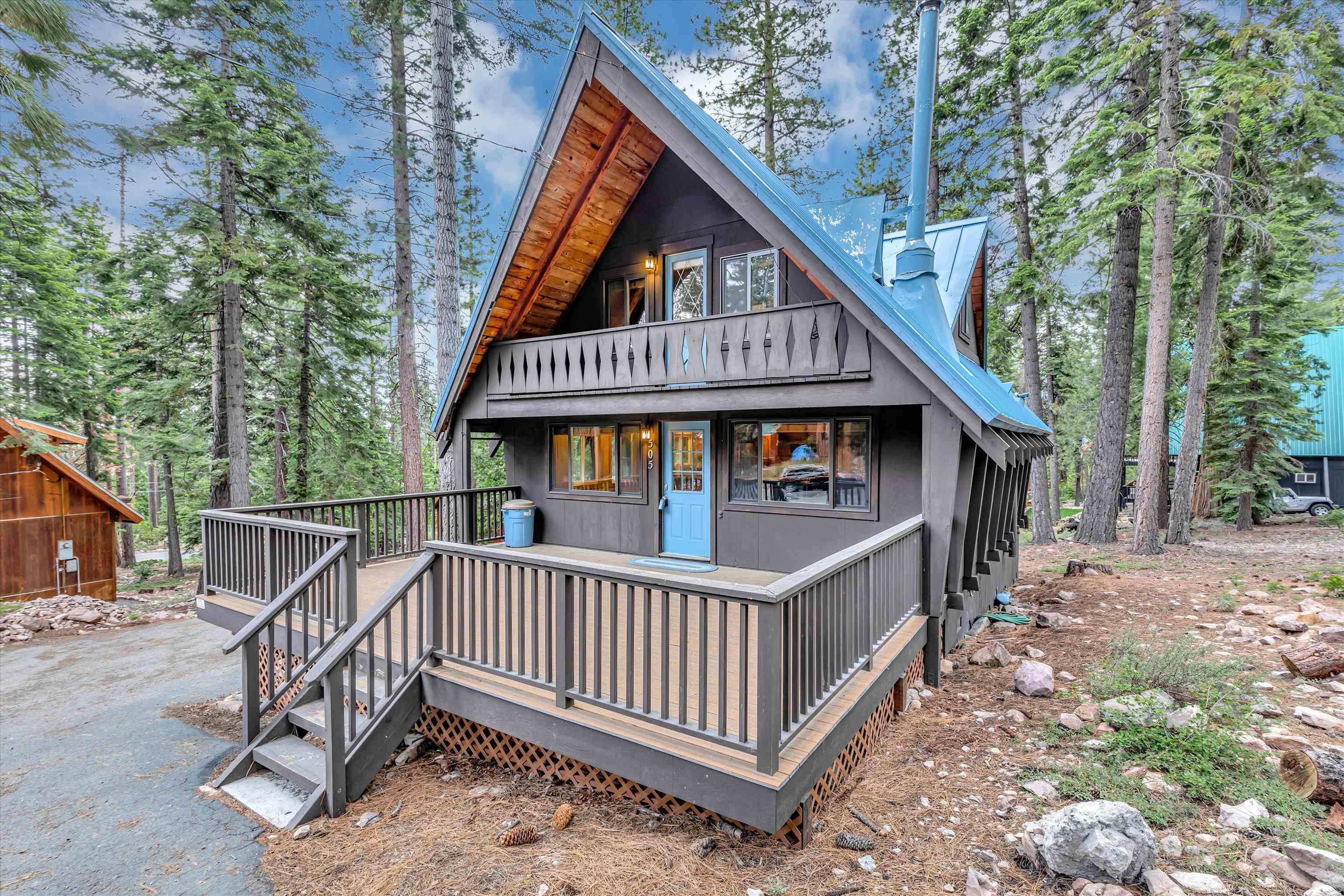 505 Granite Road Carnelian Bay, CA 96140 - Photo 2 of 20 a view of wooden house with large trees and wooden fence