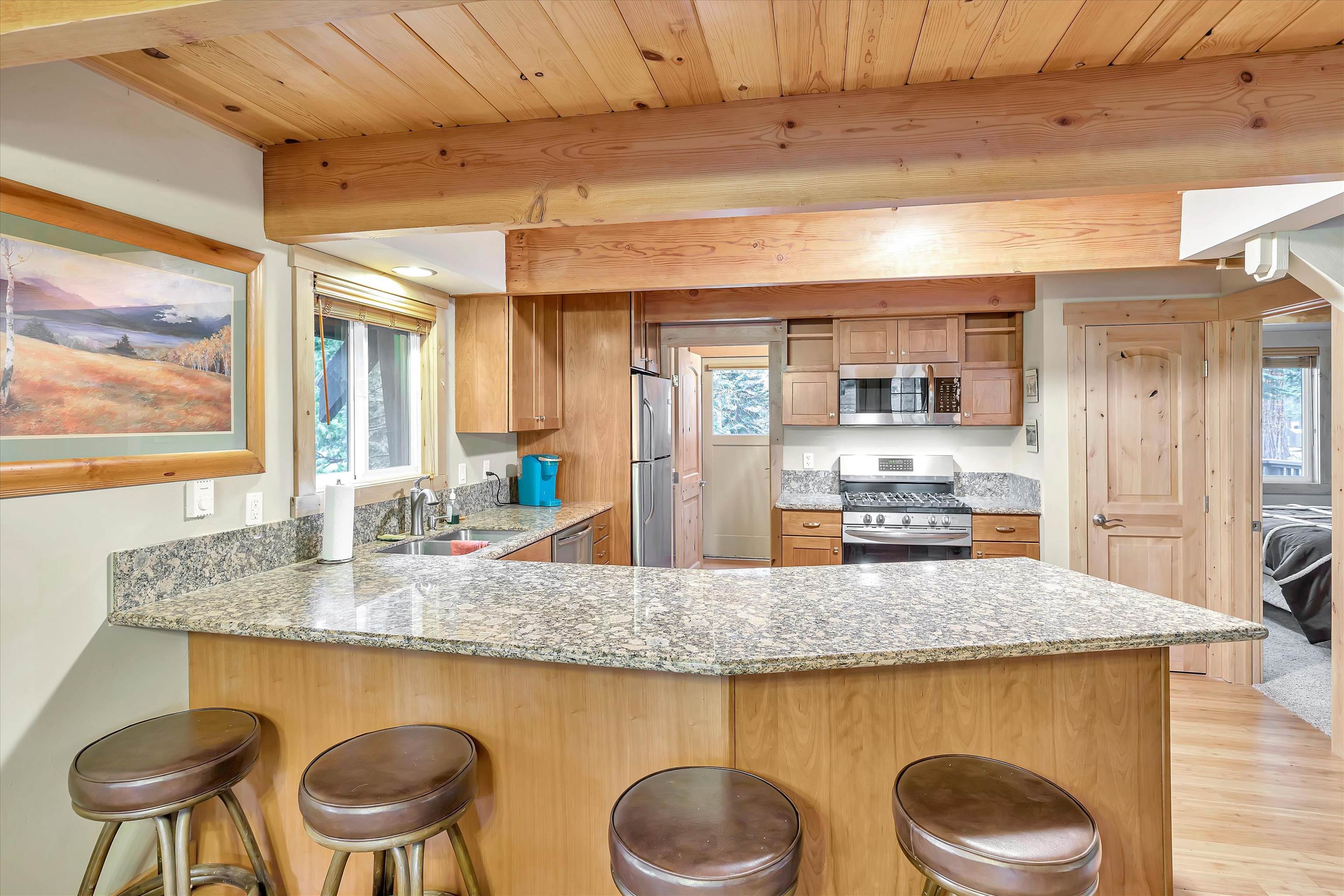 505 Granite Road Carnelian Bay, CA 96140 - Photo 8 of 20 a kitchen with kitchen island a table and chairs in it