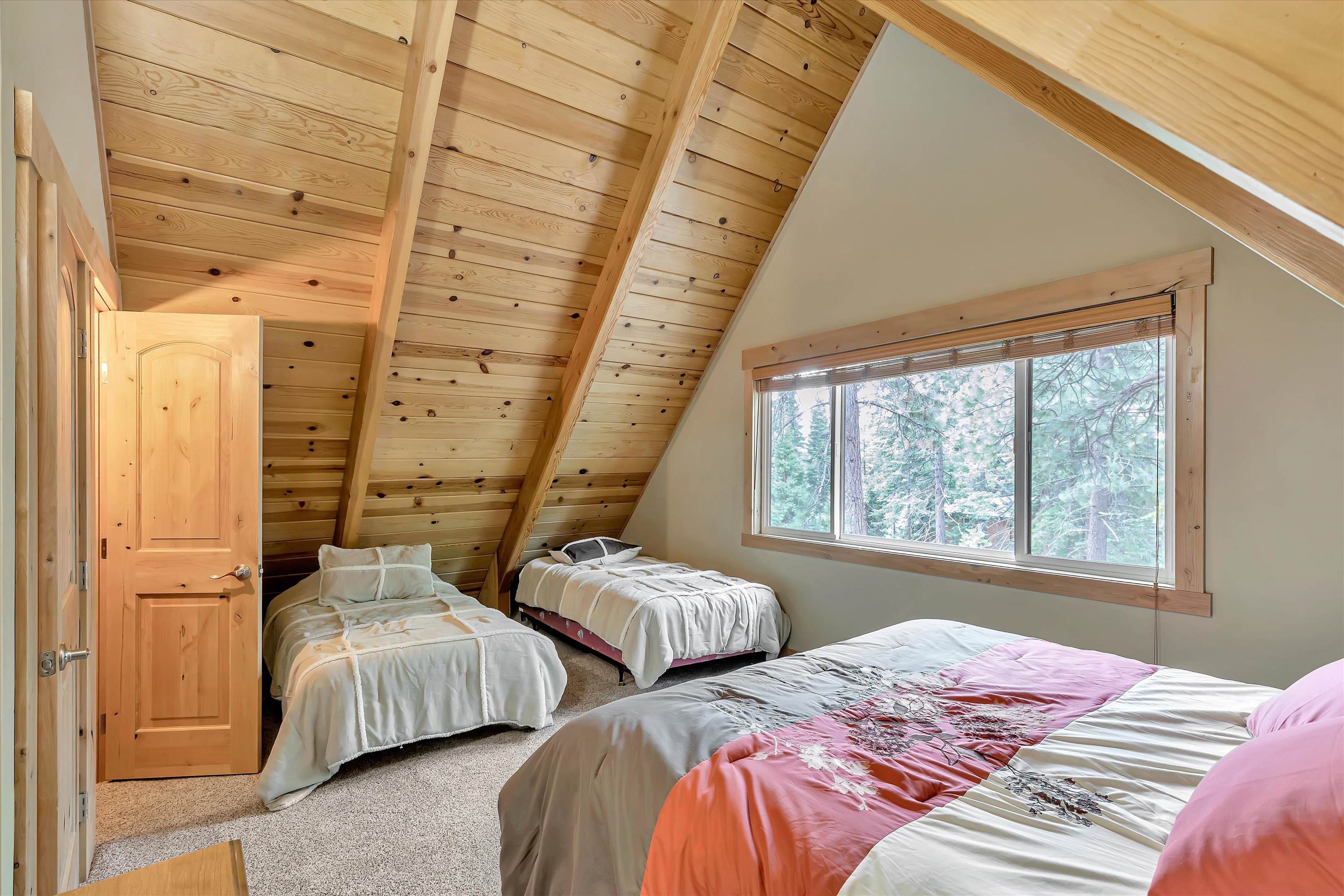 505 Granite Road Carnelian Bay, CA 96140 - Photo 10 of 20 a bedroom with two beds and next to a window