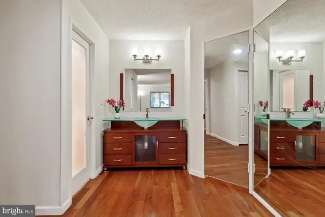 a white house with a big yard and large trees