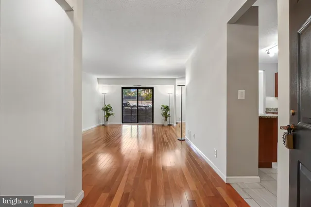 a view of walk in closet with wooden floor
