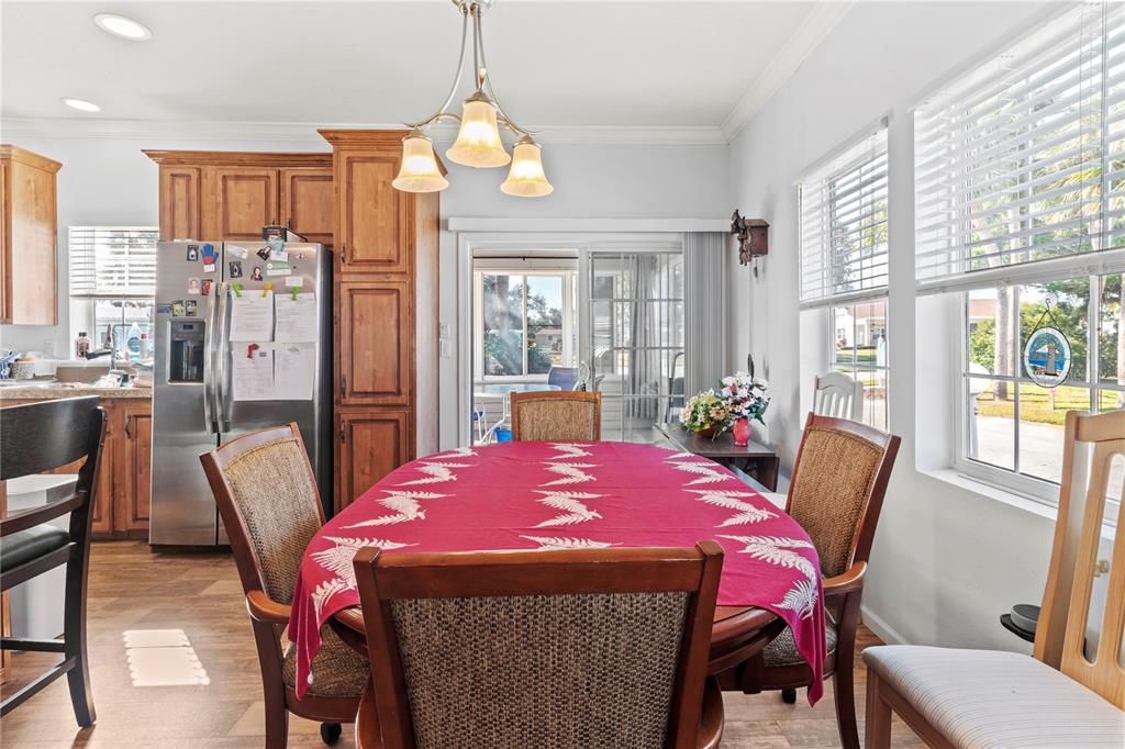 1 Meadow Circle Ellenton, FL 34222 - Photo 11 of 52 a dining room with furniture a chandelier and wooden floor
