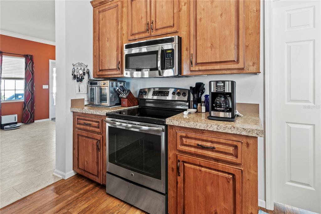 1 Meadow Circle Ellenton, FL 34222 - Photo 13 of 52 a kitchen with granite countertop a stove top oven microwave and cabinets