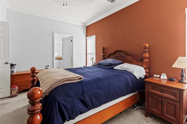 a bed sitting in a bedroom next to a window