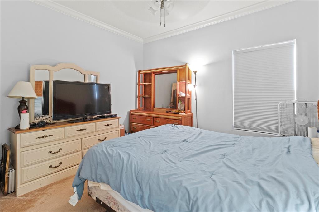 1 Meadow Circle Ellenton, FL 34222 - Photo 23 of 52 a bedroom with a bed and a flat screen tv in it