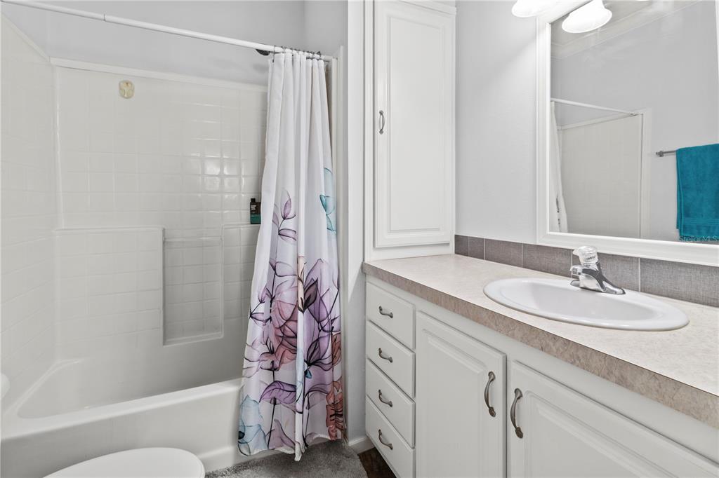 1 Meadow Circle Ellenton, FL 34222 - Photo 24 of 52 a bathroom with a granite countertop sink toilet and shower