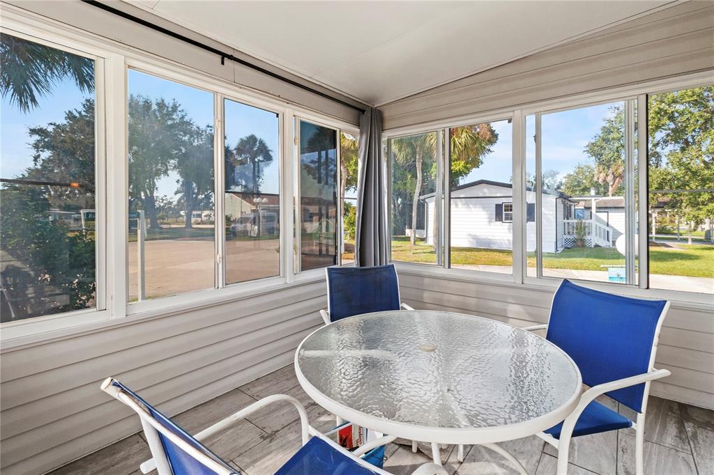1 Meadow Circle Ellenton, FL 34222 - Photo 26 of 52 a dining room with furniture large windows and wooden floor