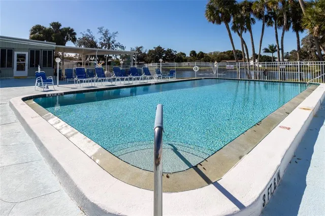 a view of a swimming pool with a patio