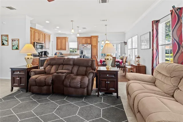 a living room with furniture and a chandelier