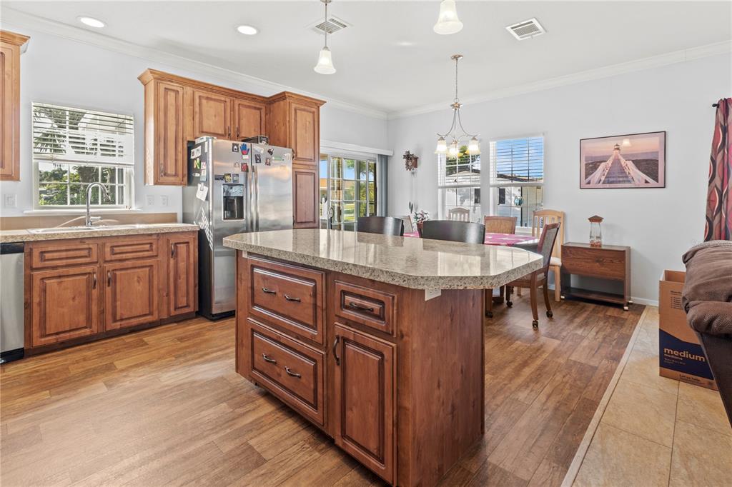 1 Meadow Circle Ellenton, FL 34222 - Photo 9 of 52 a kitchen with stainless steel appliances granite countertop a stove refrigerator and a sink