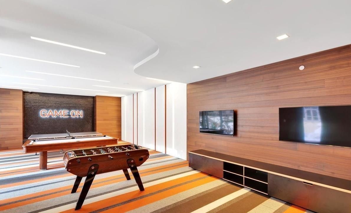 50 Riverside Boulevard, Unit 11H Manhattan, NY 10069 - Photo 13 of 37 a living room with furniture pool table and a flat screen tv