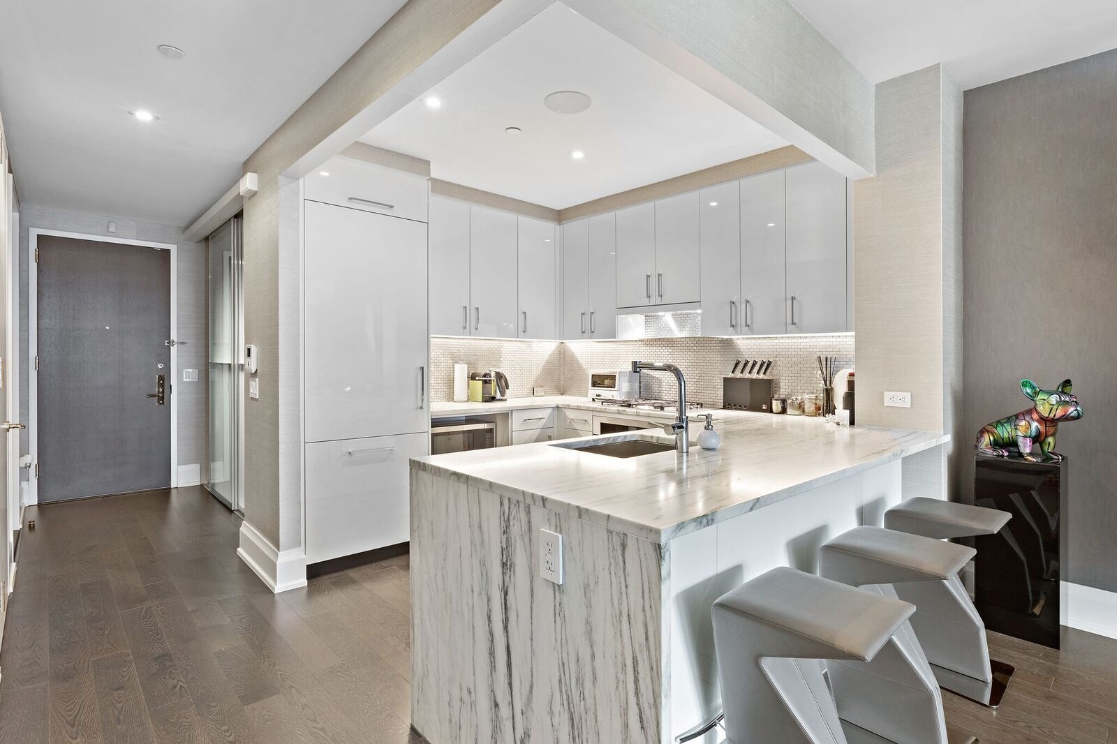50 Riverside Boulevard, Unit 11H Manhattan, NY 10069 - Photo 3 of 37 a kitchen with a sink cabinets and chairs