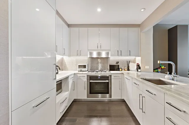 a kitchen with cabinets appliances and a sink