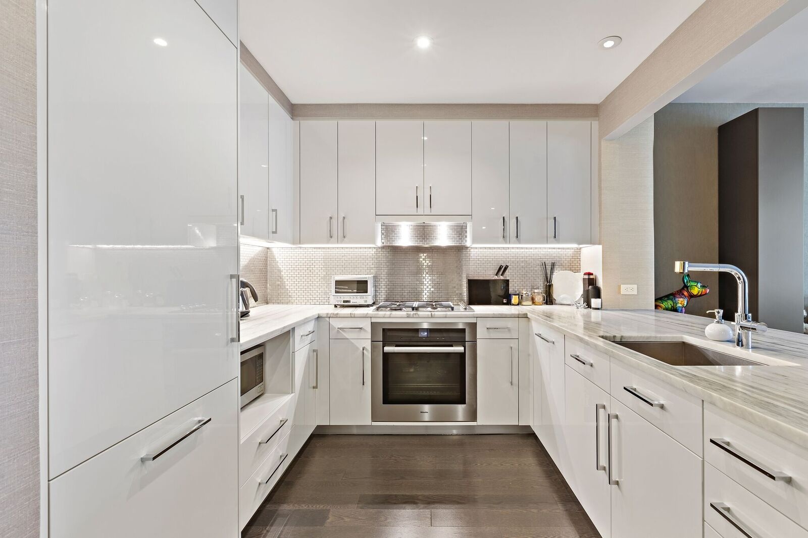 50 Riverside Boulevard, Unit 11H Manhattan, NY 10069 - Photo 4 of 37 a kitchen with cabinets appliances and a sink