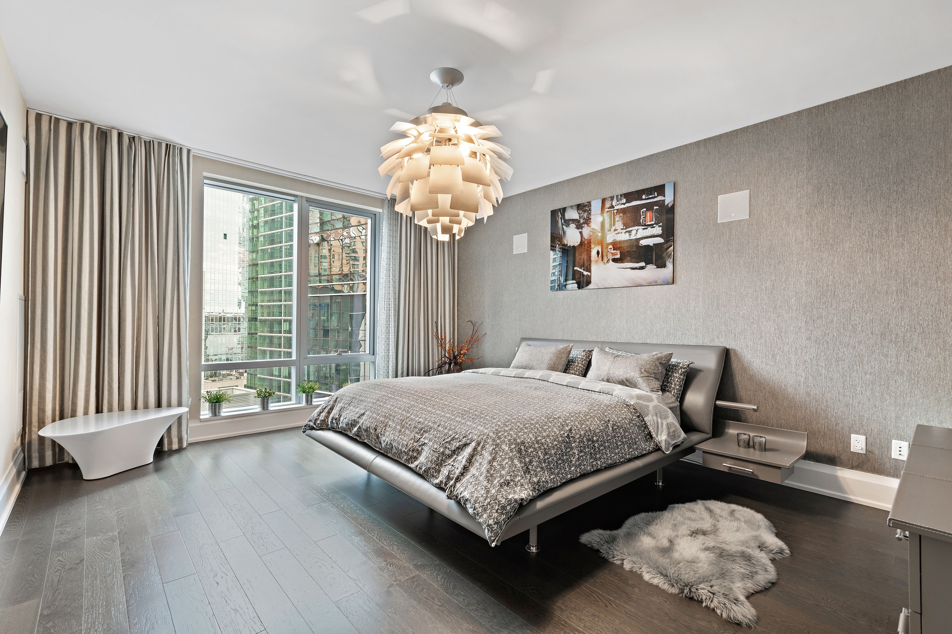 50 Riverside Boulevard, Unit 11H Manhattan, NY 10069 - Photo 6 of 37 a bedroom with a bed and a chandelier